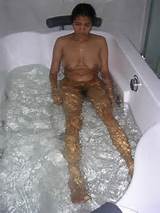 indian wife radha in hot bath tub giving her man a blowjob
